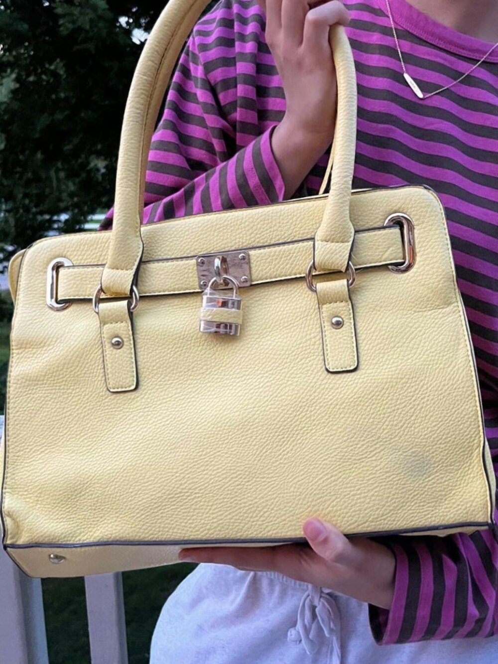 Charming Charlie "Lady Lockbox" Belted Padlock Satchel in pastel yellow.